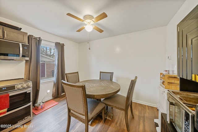 dining area with hardwood / wood-style flooring and ceiling fan