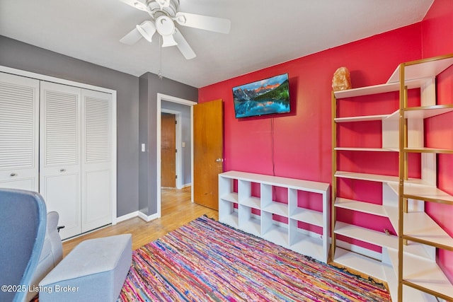 interior space featuring hardwood / wood-style floors, ceiling fan, and a closet