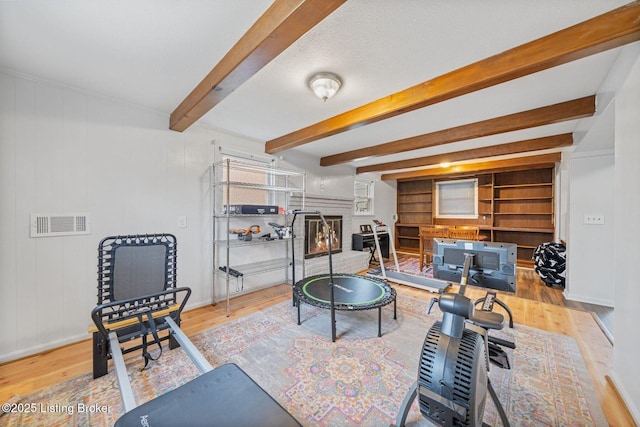 interior space with beam ceiling and light wood-type flooring