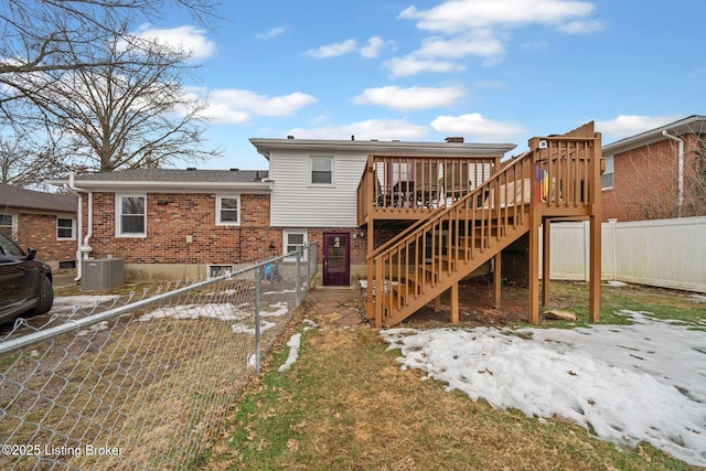 back of property with a deck and central AC unit