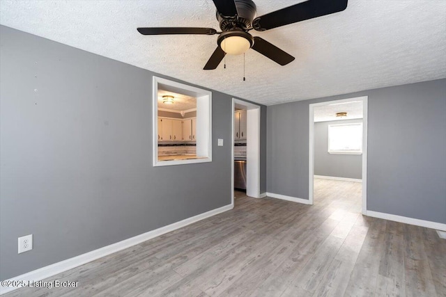 unfurnished room featuring light hardwood / wood-style flooring and a textured ceiling