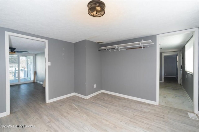 empty room with wood-type flooring and a textured ceiling