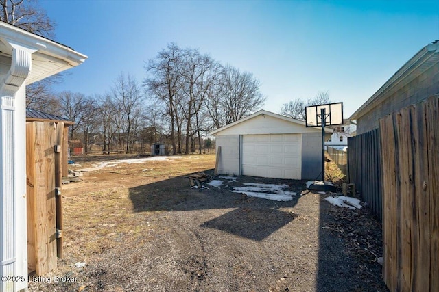 view of yard featuring a garage and an outdoor structure