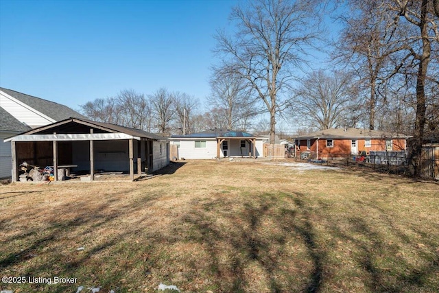 back of property featuring an outbuilding and a lawn