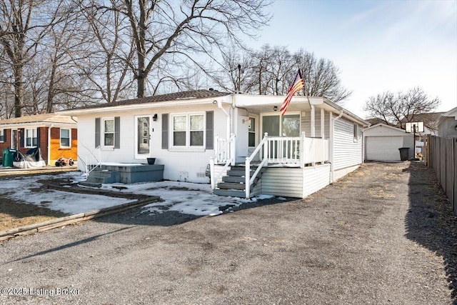 view of front of home with a garage and an outdoor structure