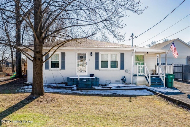 view of front of property with central AC unit and a front lawn