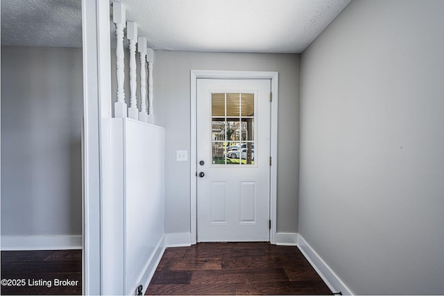 entryway featuring dark hardwood / wood-style flooring and a textured ceiling