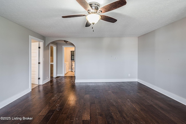 spare room with ceiling fan, dark wood-type flooring, and a textured ceiling