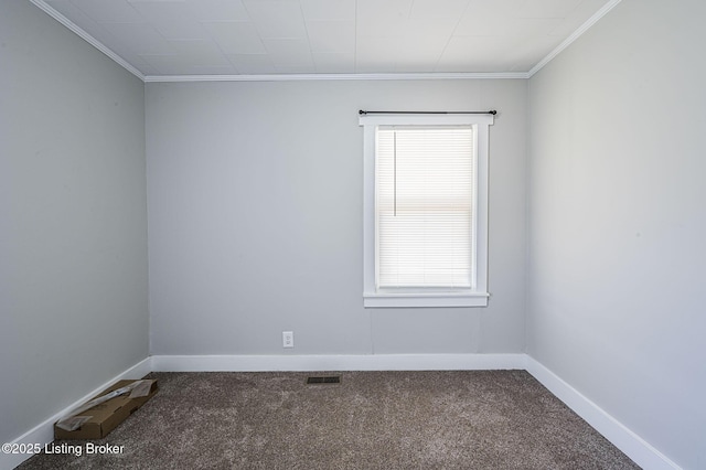 carpeted empty room featuring plenty of natural light and ornamental molding