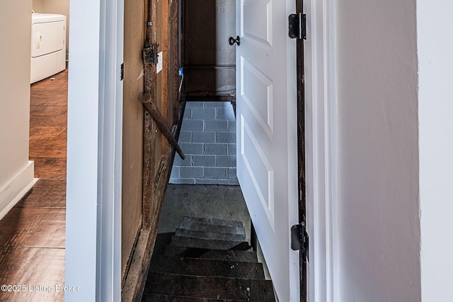 stairway with washer / dryer and wood-type flooring