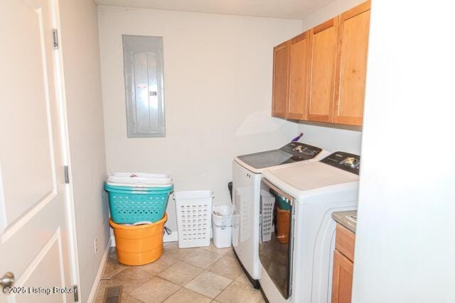 clothes washing area with cabinets, washing machine and clothes dryer, electric panel, and light tile patterned floors