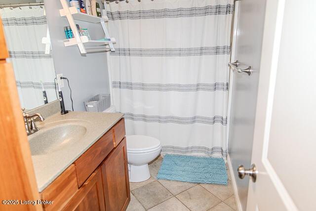 bathroom featuring tile patterned flooring, vanity, and toilet