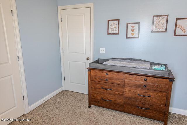 bedroom featuring light colored carpet