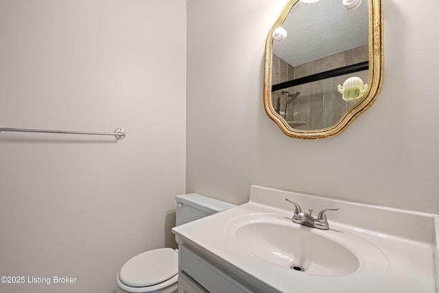 bathroom with vanity, toilet, and a shower with shower door