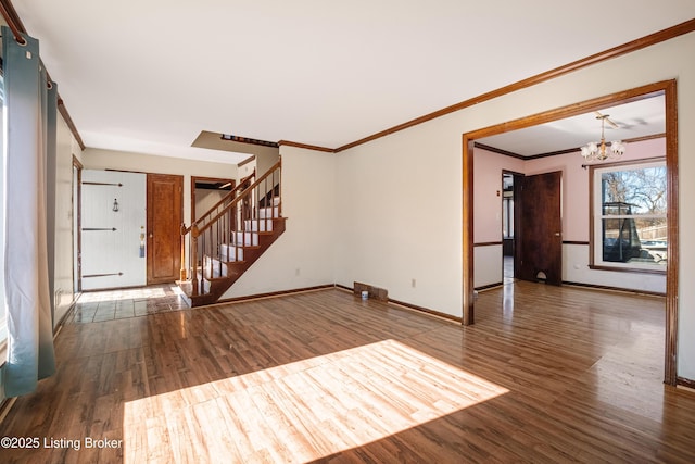 unfurnished living room featuring ornamental molding, dark hardwood / wood-style floors, and a notable chandelier