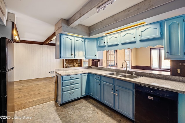 kitchen with beamed ceiling, black appliances, sink, kitchen peninsula, and blue cabinetry