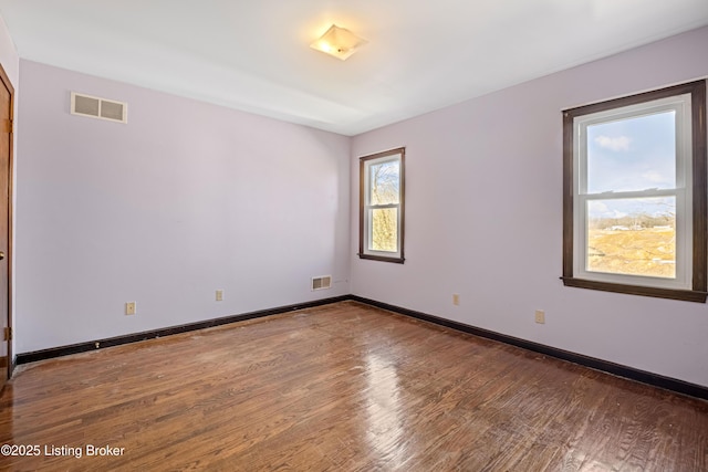 spare room with hardwood / wood-style floors