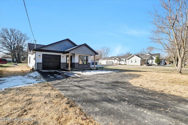 view of front of property with a garage and a front lawn