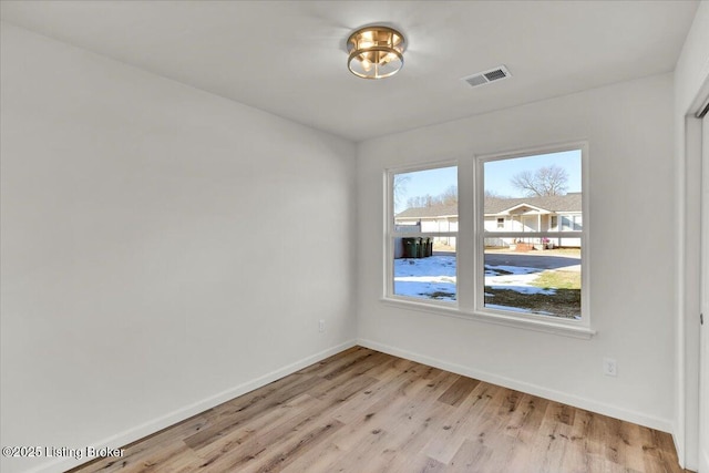 unfurnished room with light hardwood / wood-style flooring