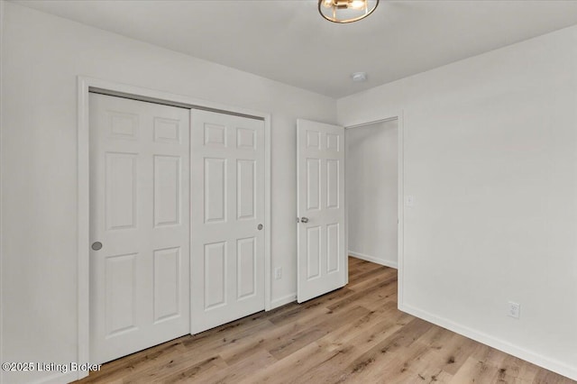 unfurnished bedroom featuring a closet and light hardwood / wood-style flooring