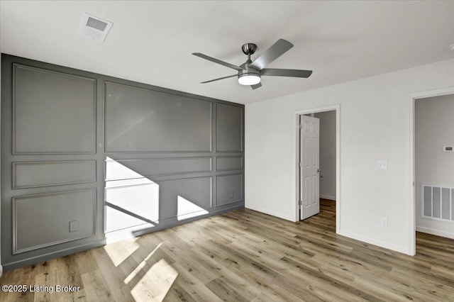 unfurnished bedroom with hardwood / wood-style flooring and ceiling fan