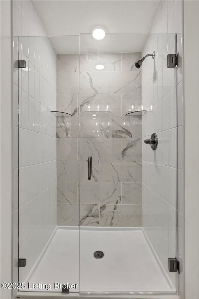 bathroom featuring a shower with door