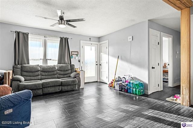 living room featuring a textured ceiling and ceiling fan