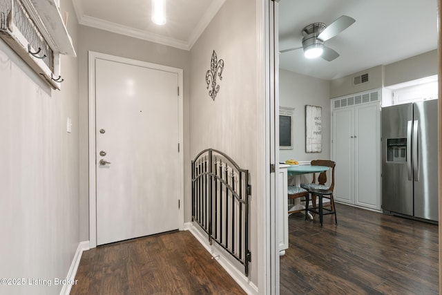 interior space featuring dark wood-type flooring, ornamental molding, and ceiling fan