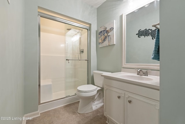 bathroom featuring vanity, a shower with door, and toilet