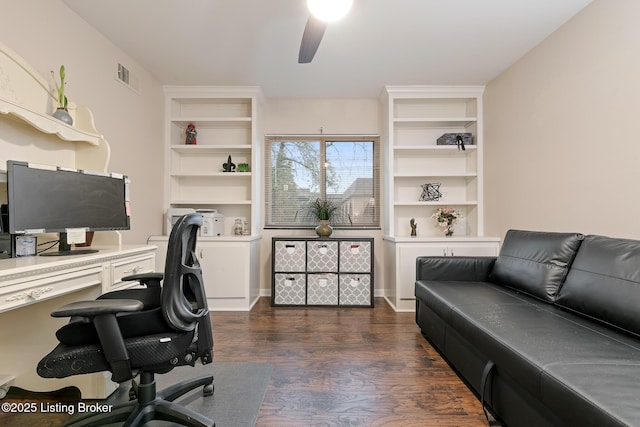 home office with dark hardwood / wood-style floors, ceiling fan, and built in shelves