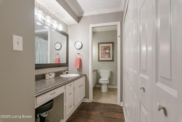 bathroom with crown molding, wood-type flooring, vanity, and toilet