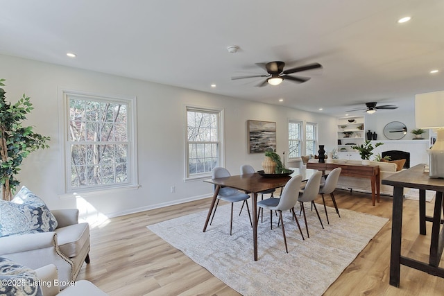 dining area with plenty of natural light, ceiling fan, and light wood-type flooring