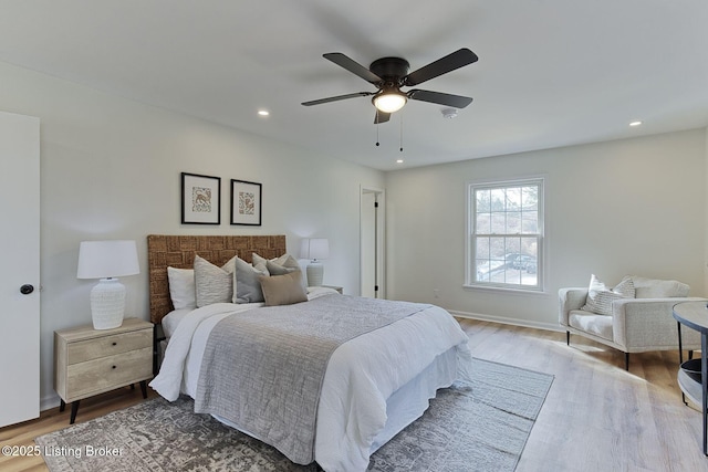 bedroom with hardwood / wood-style floors and ceiling fan