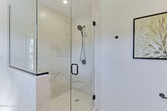 bathroom featuring a shower with door