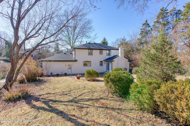 back of house with a lawn