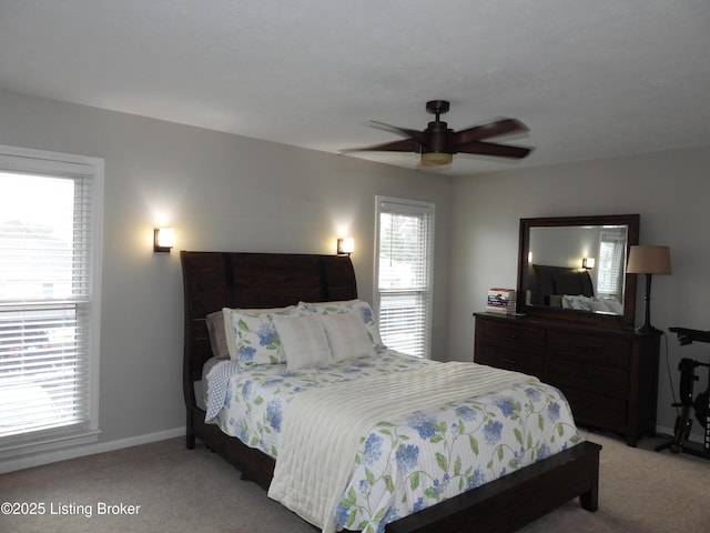 carpeted bedroom featuring multiple windows and ceiling fan