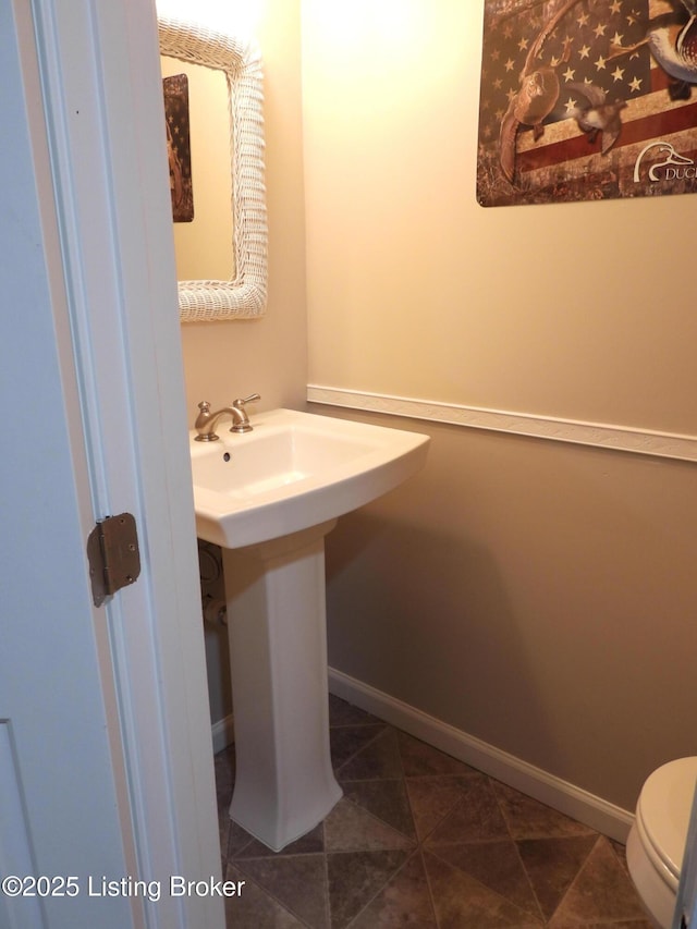 bathroom with tile patterned flooring, sink, and toilet