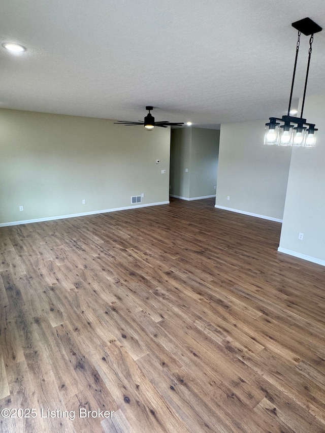 unfurnished living room featuring a textured ceiling, wood-type flooring, and ceiling fan