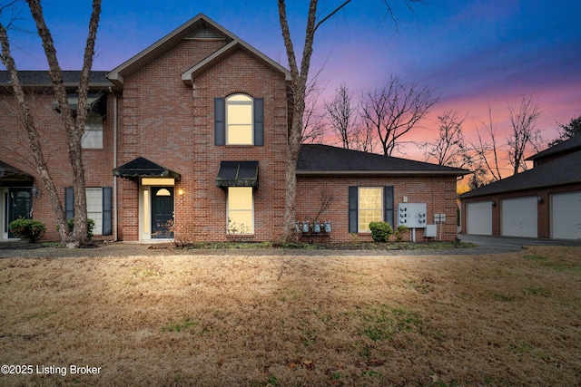 view of front property with a garage and a lawn