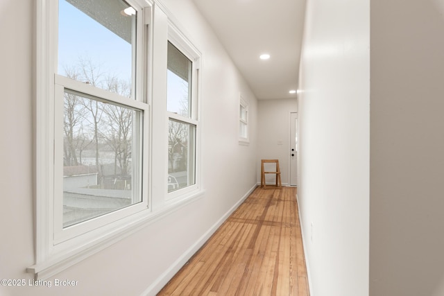 hall with light hardwood / wood-style flooring