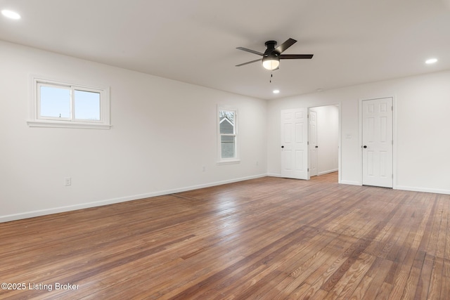 empty room with ceiling fan and hardwood / wood-style floors