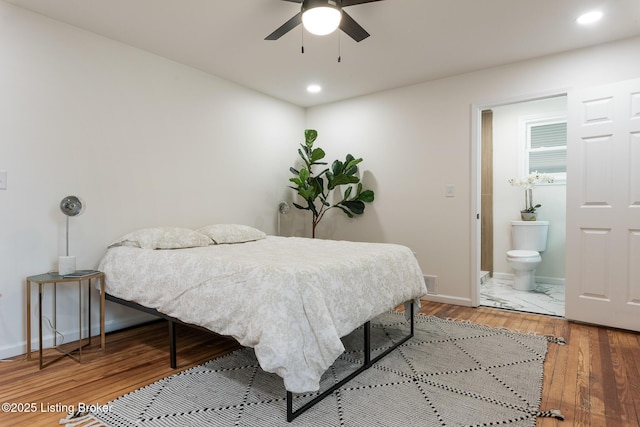 bedroom with hardwood / wood-style flooring and ensuite bathroom