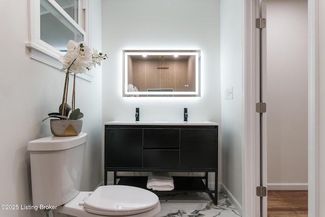 bathroom featuring vanity and toilet