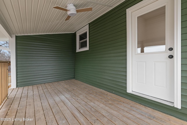 wooden deck featuring ceiling fan