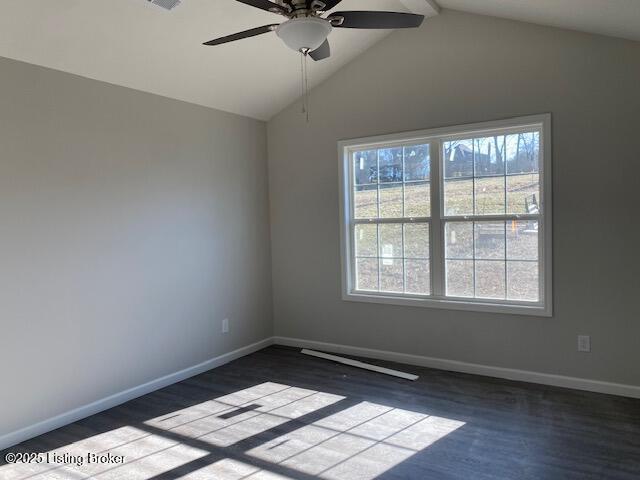 unfurnished room featuring hardwood / wood-style flooring, a wealth of natural light, lofted ceiling with beams, and ceiling fan