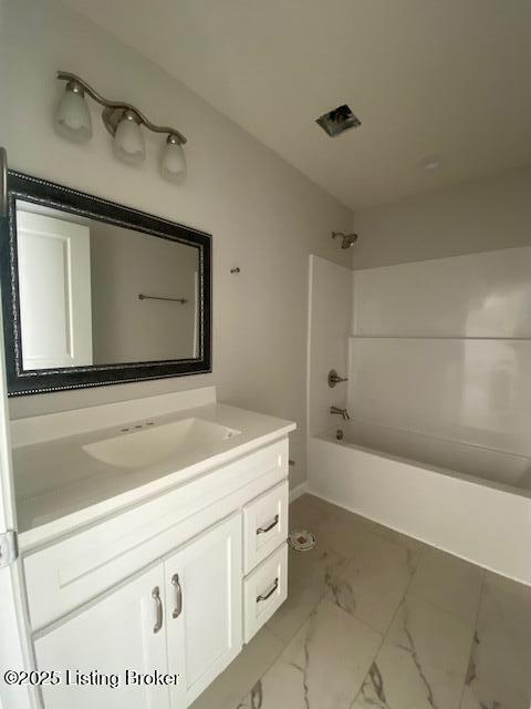 bathroom with vanity and shower / washtub combination