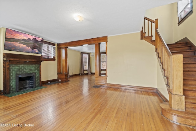1615 Stevens Ave, Louisville, KY 40205 - unfurnished living room featuring wood-type flooring, a fireplace, stairs, and baseboards