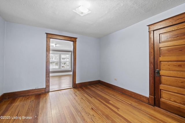 1615 Stevens Ave, Louisville, KY 40205 - unfurnished room featuring a textured ceiling, light wood-style flooring, and baseboards