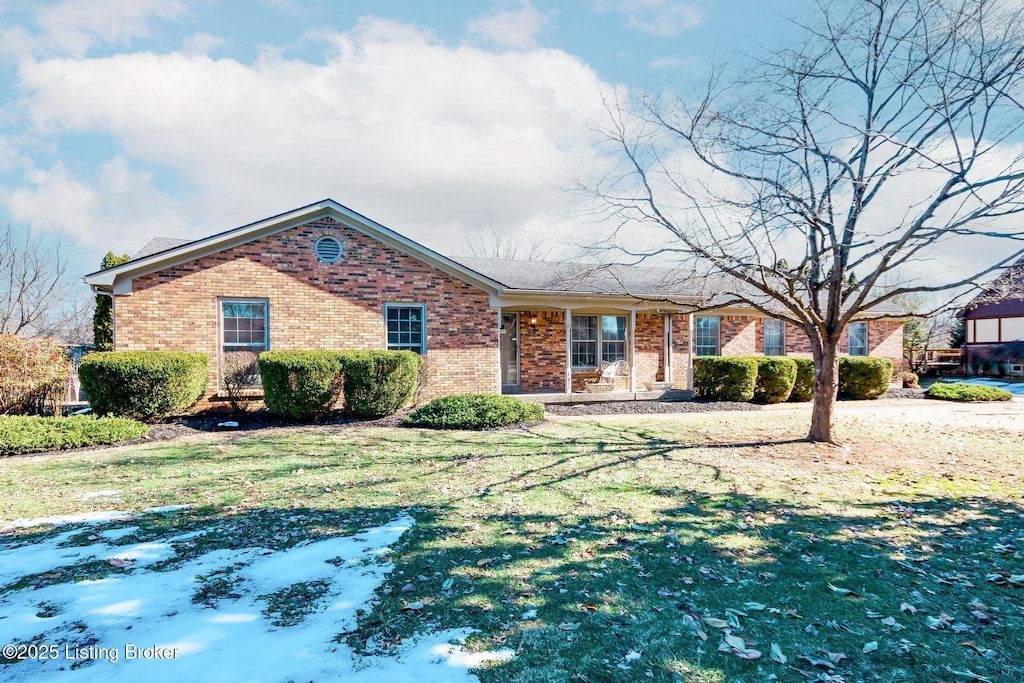 ranch-style home with a front lawn