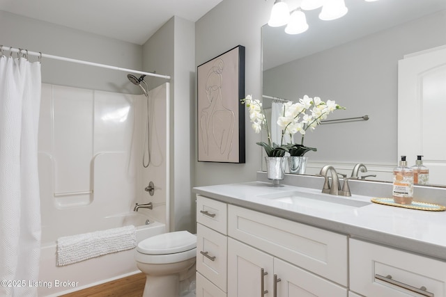 full bathroom with shower / tub combo with curtain, vanity, and toilet